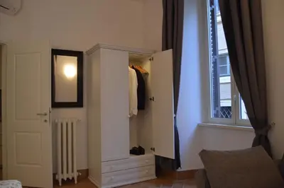 a room with a closet with a mirror and a window at Leoncino 36 Apartments in Rome in Rome