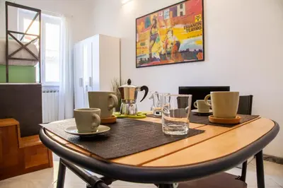 a wooden table with cups and drinks on it at Ton Ton by Ghor in Rome