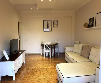 a living room with a couch and a table at La Casa Libre Metro A Colli Albani 350 m in Rome