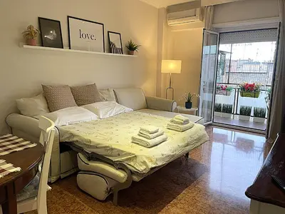 a small room with a bed and a table at La Casa Libre Metro A Colli Albani 350 m in Rome