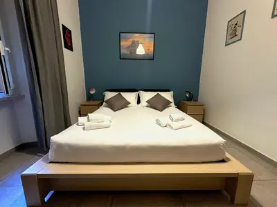 a bedroom with a large white bed with two pillows at San Giovanni Apartment in Rome