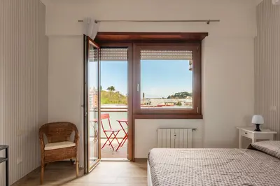 a bedroom with a bed and a window with a view at GuestHost - Valle Aurelia Elegant Apartment in Rome