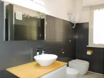 a bathroom with a sink and a toilet at Kalu apartment in Rome