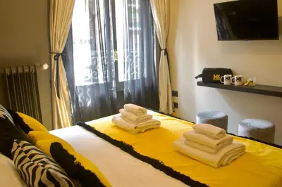 a room with a bed with towels on it at XCross Suites Roma in Rome
