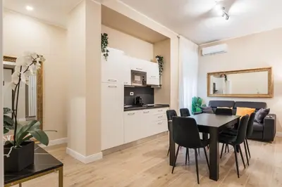 a living room with a dining room table and a kitchen at Italy House in Rome