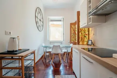 a kitchen with a table and chairs in a room at Art House Vaticano Apartment in Rome