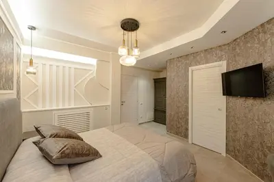 a bedroom with a bed and a tv on a wall at Bed & Breakfast Il Narciso in Rome