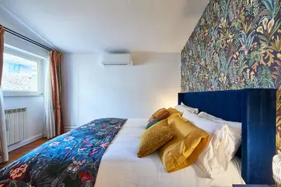 a bedroom with a bed with a colorful head board at La Dolce Vita Rooftop Suite in Rome
