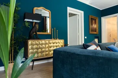 a blue living room with a blue couch and a mirror at La Dolce Vita Rooftop Suite in Rome
