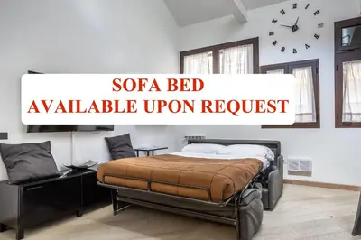 a bedroom with a bed and a clock on the wall at Trastevere Double A LOFT in Rome