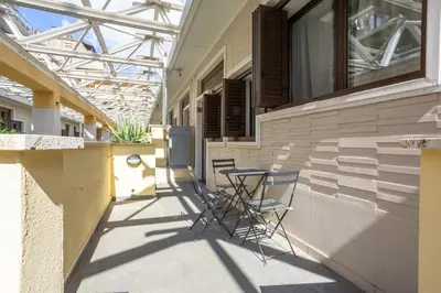 a patio with chairs and a table on the side of a building at Trastevere Double A LOFT in Rome