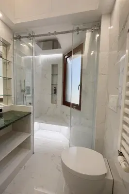 a white bathroom with a toilet and a shower at èROMA - SAN PAOLO BASILICA Apartment in Rome