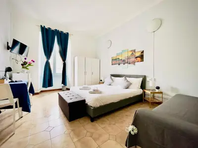 a large bedroom with a bed and a couch at Rome Room Vatican in Rome