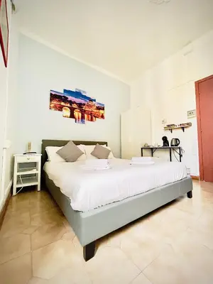 a bedroom with a large bed in a room at Rome Room Vatican in Rome