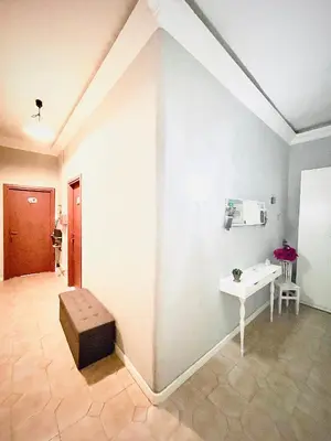 a room with a white wall with a bench and a table at Rome Room Vatican in Rome