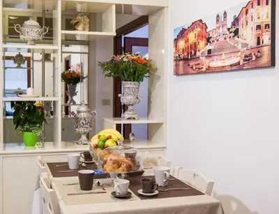 a table with a plate of food on it at Residenza dei Pontefici in Rome