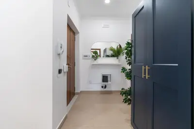 a hallway with a blue door and a hallway with plants at San Giovanni Boutique Suites in Rome