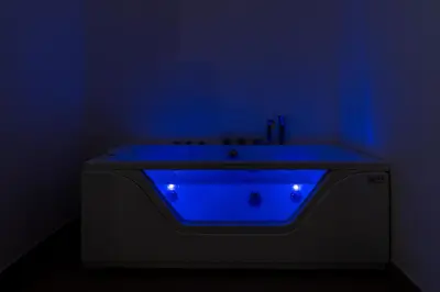a bath tub with a blue light in a bathroom at San Giovanni Boutique Suites in Rome