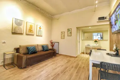 a living room with a couch and a table at Lovely 2 Bedroom apartment by YourHost in Rome