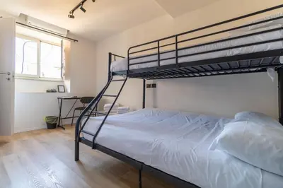 a bedroom with two bunk beds and a window at Cunabu Urbano in Rome