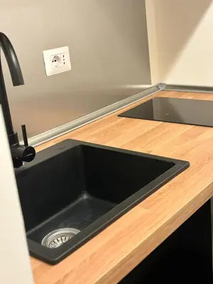 a kitchen with a black sink in a counter at Flaminia's House San Pietro Station in Rome