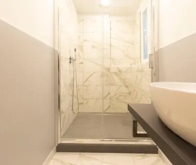 a bathroom with a shower and a sink at Cozy Tritone - My Extra Home in Rome
