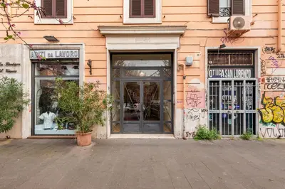 a store with graffiti on the side of a building at Termini Station Lightsome 3BR Apartment in Rome