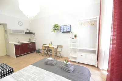 a room with a bed and a kitchen and a table at Prati House in Rome