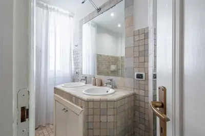 a bathroom with a sink and a mirror at Your elegant Loft at Termini Station in Rome