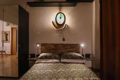a bedroom with a bed and a mirror on the wall at cos24 in Rome