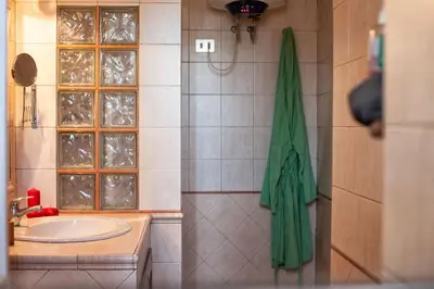 a bathroom with a sink and a green towel at Vatican R-Home Savorelli in Rome