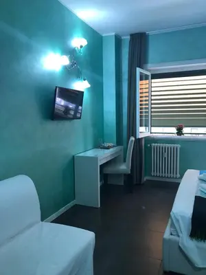a bedroom with a bed with two people in towels at B&B Roma in Rome