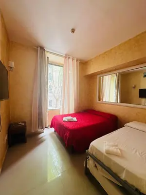 a bedroom with two beds and a window at Termini Sunlight House in Rome