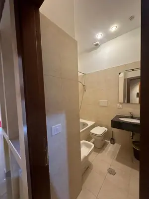 a bathroom with a toilet and a sink at Termini Sunlight House in Rome