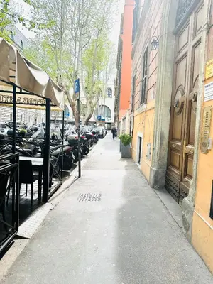 a city street with parked cars on the side at Termini Sunlight House in Rome