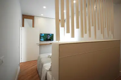 a bedroom with a bed and a tv on a wall at Peaceful 2 Bedrooms with patio, near Metro A in Rome