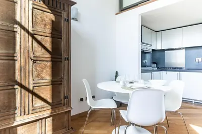 a dining room with a white table and white chairs at [Trastevere Lux* * * * *] - Roma Centro Storico in Rome