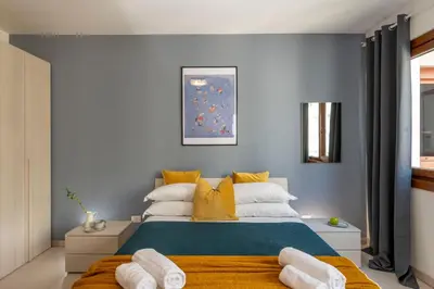a bedroom with a large bed with yellow pillows at San Paolo Home in Rome