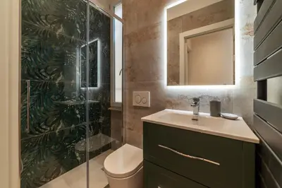 a bathroom with a sink and a glass shower at GuestHost - Rome Huge & Cozy Apartment in Rome