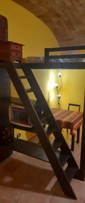 a bunk bed in a room with a table at Shiva B&B in Rome