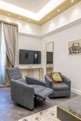 a living room with two couches and a tv at Antiqua Domus in Rome