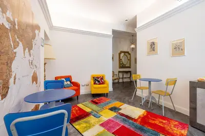 a room with two tables and chairs and a rug at Antiqua Domus in Rome