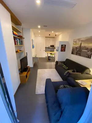 a living room with a blue couch and a tv at Apartment Villa Borghese with terrace in Rome