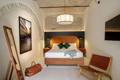 a bedroom with a bed and a chair at Officina Daplace in Rome