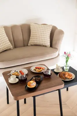 a coffee table with plates of food on it at Sistina Boutique Guest House in Rome