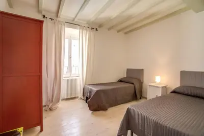 a bedroom with two beds and a window at Three Bedroom Apartment Campo dei Fiori in Rome