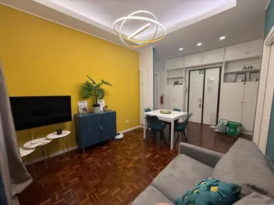a living room with a couch and a table at La Casa di Rosa , Elegante Appartamento a Corso Trieste, Metro B in Rome