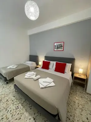 a hotel room with two beds with towels on them at Trastevere Station Sweet Rest in Rome