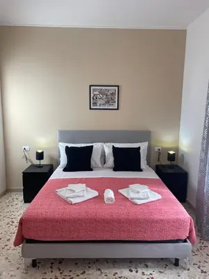 a bedroom with a large bed with two towels on it at Trastevere Station Sweet Rest in Rome