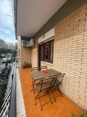 a picnic table on the balcony of a building at Trastevere Station Sweet Rest in Rome